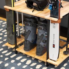 a pair of snowboard boots sitting on top of a wooden shelf