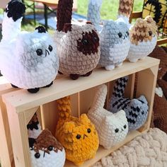 crocheted stuffed animals are displayed on shelves