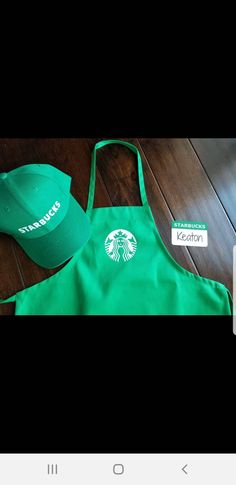 the starbucks apron and hat are on display