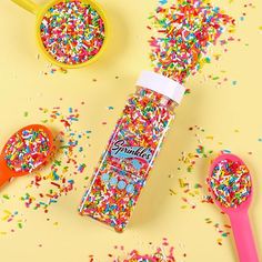 sprinkles and spoons on a yellow surface