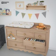 a baby's room with a crib and dresser