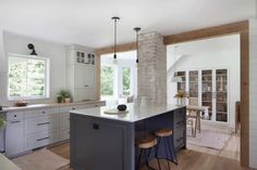 a kitchen with an island and two stools