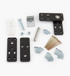 an assortment of hardware and screws on a white surface