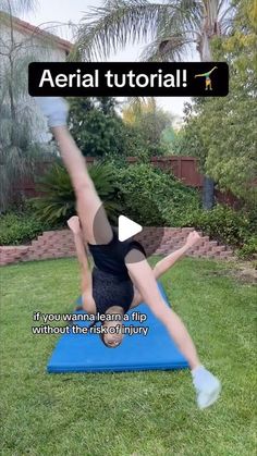 a woman is doing an aerial yoga pose on a blue mat in the yard with words above her