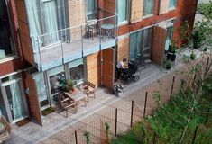 an apartment building with wooden balconies and patio furniture on the upper level balcony