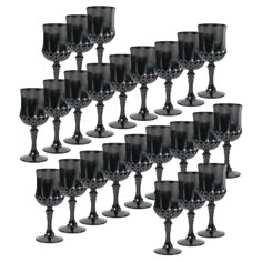 a bunch of black goblets sitting next to each other on a white background