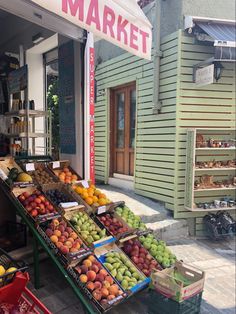 the fruit stand has many different types of fruits on display for sale in front of it