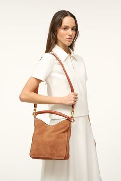 A mid-size shoulder bag, the Mel features a hand wrapped handle detail. This style features one shorter strap and one longer strap that can be worn to create two different looks. Chic Hobo Bag With Adjustable Strap And Round Handle, Chic Leather Hobo Bag With Rolled Handles, Luxury Brown Hobo Bag With Rolled Handles, Versatile Shoulder Bag With Rolled Handles For Work, Brown Shoulder Bag With Rolled Handles For Work, Versatile Shoulder Bag For Workwear With Rolled Handles, Versatile Shoulder Bag For Work With Rolled Handles, Brown Hobo Bag With Rolled Top Handles, Work Shoulder Bag With Round Leather Handles