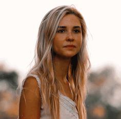 a woman with long blonde hair holding a tennis racquet