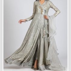 Brand New Without Tags Slim Fitting Top Length 61.5 Shoulders 13.5 Arm Hole 7.5 Bust 17 Waist 18 Pant Length 35.5 Pant Waist 25 (Elastic) Pant Thigh 20 Top, Dupatta And Pants Included. Designer- Ayesha Somaya A Beautiful Flowing Angrakha In Steel Grey Chikan Kari With Heavy Sequins. Embellished With A Crystal Motif And Long Tassel On Front Bodice. Organza Drape Dupatta And Pants Are Included In The Set. Dupatta Can Be Made In Simple 3 Yard With Finish Upon Request. Elegant Full-length Gown With Dupatta, Elegant Full Length Gown With Dupatta, Festive Silver Floor-length Dupatta, Elegant Silver Floor-length Dupatta, Silver Floor-length Bollywood Dupatta, Silver Bollywood Style Floor-length Dupatta, Floor-length Silver Sheer Dupatta, Drape Dupatta, Pant Length