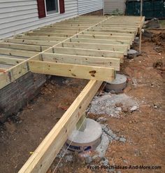 an unfinished deck being built in front of a house