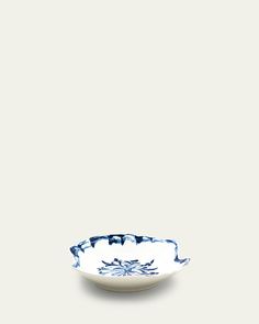 a blue and white bowl sitting on top of a table