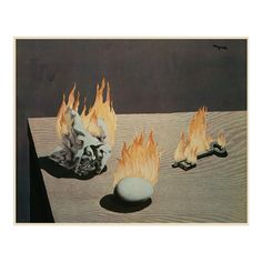 three objects with fire on them sitting on top of a table