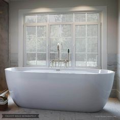 a large white bath tub sitting next to a window