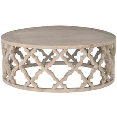 a round wooden table sitting on top of a white floor