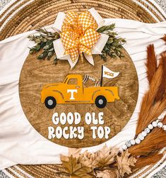 a wooden sign that says, good olee rocky top with an orange truck on it