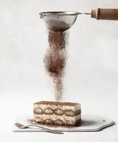 a piece of cake is being sprinkled with powder