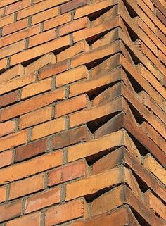 the corner of a brick building that is made out of bricks