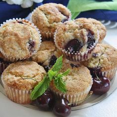 a white plate topped with muffins and cherries