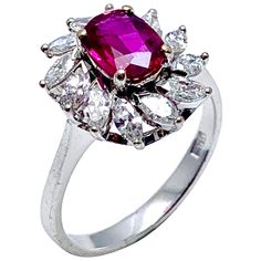 A vibrant currant red 1.00 carat Ruby and marquise Diamond engagement/cocktail ring in 14 karat white gold. The Ruby is uniquely set slightly off center in conjunction with the slant set marquise Diamonds. The 12 Diamonds have a total carat weight of 1.20 carats, graded as F-G color, VS clarity on a tapered shoulder shank. The ring is currently a size 8.00 (adjustable as needed). Offered by Charles Schwartz & Son Jewelers. Unique Engagement Rings Rose Gold, Victorian Engagement Rings, Marquise Diamond Engagement Ring, Contemporary Engagement Rings, Gold Diamond Engagement Rings, Stunning Engagement Ring, Diamond Cocktail Rings, Yellow Gold Engagement, Yellow Gold Engagement Rings