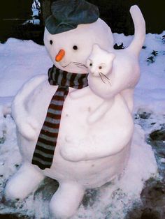 a snowman is holding a cat in his arms