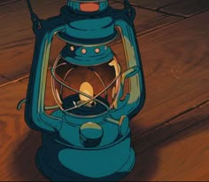 a blue lantern sitting on top of a wooden floor