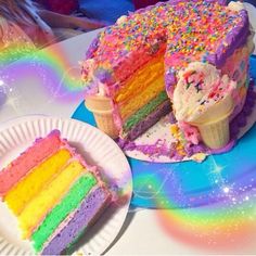 a rainbow cake with ice cream and sprinkles sits on a plate next to an ice cream cone