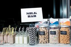 there are many different types of milks on the table with straws in front of them