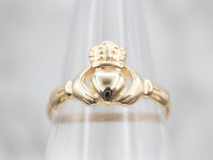 Claddagh rings are a traditional token of affection, with the crown, heart, and hands representing loyalty, love, and friendship. This piece would make a special promise ring or wedding band!Metal: 14K Yellow GoldWidth of Band: 9.7 mmHeight off Finger: 2.2 mmRing Size: 6 Classic Crown Shaped Promise Ring, Classic Crown Design Promise Ring, Classic Crown Promise Ring, Classic Crown Ring For Formal Occasions, Classic Round Rings With Crown Design, Classic Yellow Gold Rings With Crown Design, 14k Gold Crown Design Anniversary Rings, Anniversary Crown Shaped 14k Gold Ring, Yellow Gold Crown Promise Ring