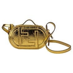 Fendi oval mini bag in gold laminated leather. Zip fastening with double slider. Outer back pocket. Featuring a lined internal compartment and gold-finish metalware. Handle drop 1.5”, detachable strap 18.5”. The bag is new and comes with the original dustcover. Gold For Sale, Mini Camera, Camera Case, Fashion Handbags, Dream Life, Evening Bags, Mini Bag, Fendi, Handbags