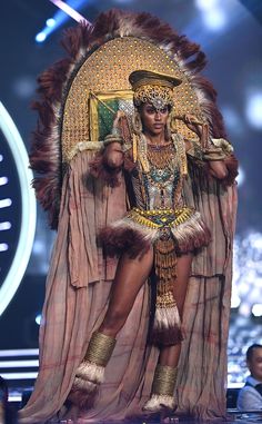 a woman dressed in an elaborate costume on stage