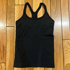 Excellent Condition Never Worn Size 8 Lululemon Tank Top Black Racer Back Black Seamless Tank Top For Workout, Black Seamless Workout Tank Top, Black Seamless Tank Activewear, Black Seamless Athleisure Top, Black Stretch Tank Top For Light Exercise, Black Tank Top For Light Exercise With Seamless Construction, Black Workout Top With Seamless Construction, Black Seamless Racerback Top, Black Tank Activewear For Light Exercise