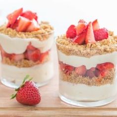 two desserts with strawberries are sitting on a table