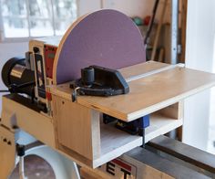 a workbench with tools on it in a room filled with woodworking equipment