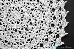 the crocheted doily is made from white yarn