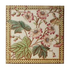 a tile with flowers and leaves on it