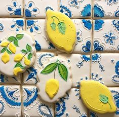 three decorated cookies sitting on top of blue and white tiles