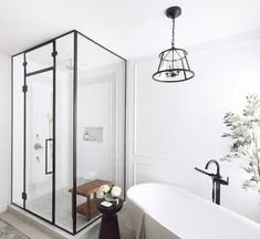 a white bath tub sitting next to a walk in shower