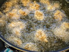 a pan filled with food cooking on top of a stove