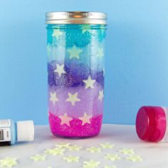 a jar with stars painted on it next to a marker