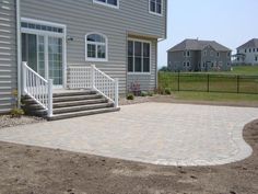 a brick patio in front of a house