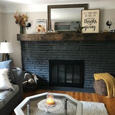 a living room with a fire place in the center and a mirror on the wall