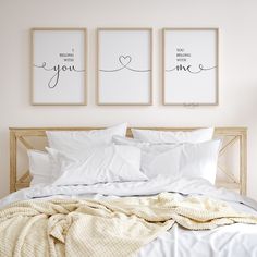 a bed with two framed pictures above it