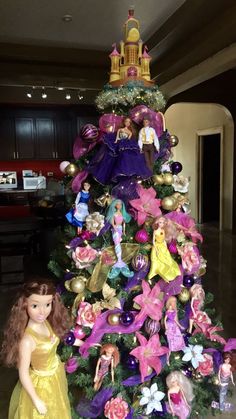 there is a christmas tree with barbie dolls on it