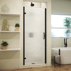 a white bath tub sitting next to a window in a bathroom with shelves on the wall