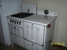 a white stove top oven sitting inside of a kitchen