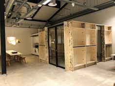 an empty room with wooden shelves in the center and tables on either side of it