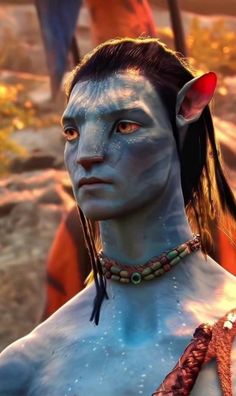 an avatar with blue paint on his face and chest, standing in front of other avatars