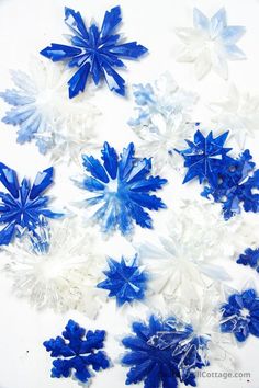 blue and white snowflakes are arranged on a table