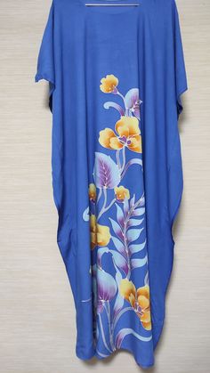 🌺 Stunning blue traditional hand-painted batik kaftan dress with vibrant floral pattern. Crafted from 100% lightweight, breathable cotton. It's perfect for hot summer days. Only 1 piece available in this design. 🌺 Great gift for her! 🌺 Follow LuxKaftan shop to receive notifications of new listings and updates: https://www.etsy.com/au/shop/LuxKaftan 🌺 Measurement: - One Size/Free-Size - Length 140cm (maxi) - Width (between stitches) 78cm - Full width 91cm 🌺 Details: - Traditional Hand-painte Blue Long Kaftan With Floral Print, Blue Long Floral Print Kaftan, Long Blue Floral Print Kaftan, Tropical Blue Kaftan For Beach Cover-up, Blue Casual Kaftan With Batik Print, Casual Blue Kaftan With Batik Print, Traditional Blue Kaftan With Batik Print, Casual Blue Batik Print Kaftan, Blue Floral Print Kaftan For Beach